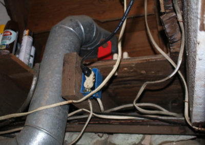 This electrical found by the home inspector needs to be cleaned up and stapled correctly and a cover should be installed on the outlet
